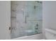 Updated shower and tub feature sleek glass doors and tiled walls at 11073 Gateview Ln, Las Vegas, NV 89144