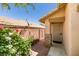 Side entrance featuring a security door, desert landscaping and privacy wall at 11073 Gateview Ln, Las Vegas, NV 89144