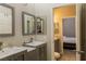 Well-appointed bathroom featuring double sinks, modern cabinetry, and a view into the bedroom at 11244 Gammila Dr, Las Vegas, NV 89141