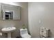 Powder room featuring pedestal sink, toilet, and tiled floors; ideal for guests at 11244 Gammila Dr, Las Vegas, NV 89141