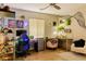 Bright bedroom with playful decor, a ceiling fan, and a comfortable workspace at 11244 Gammila Dr, Las Vegas, NV 89141