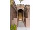 Charming home entrance featuring a gated courtyard and an arched doorway at 11244 Gammila Dr, Las Vegas, NV 89141