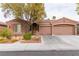 Charming single-story home with a well-manicured lawn, desert landscaping and a three-car garage at 11244 Gammila Dr, Las Vegas, NV 89141