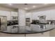 Modern kitchen featuring white cabinets, a breakfast bar, and tile backsplash at 11244 Gammila Dr, Las Vegas, NV 89141