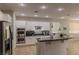 Bright kitchen with white cabinets, a modern island, and stainless steel appliances at 11244 Gammila Dr, Las Vegas, NV 89141