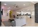 Bright, open living room with tile flooring, a ceiling fan and neutral wall paint at 11244 Gammila Dr, Las Vegas, NV 89141