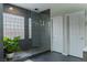 Modern shower featuring glass enclosure, unique block window, and gray tile at 11244 Gammila Dr, Las Vegas, NV 89141
