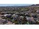 Sprawling aerial view of a residential area with mountain views and houses with solar panels at 12124 Kite Hill Ln, Las Vegas, NV 89138
