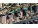 Aerial view of a community showcasing homes with solar panels and swimming pools, surrounded by trees at 12124 Kite Hill Ln, Las Vegas, NV 89138