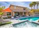 Spacious backyard showcasing a sparkling pool, hot tub, covered patio, and an orange sunshade at 12124 Kite Hill Ln, Las Vegas, NV 89138