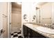 Bathroom with double sinks, granite countertop, black and white tile flooring, and shower-tub combo at 12124 Kite Hill Ln, Las Vegas, NV 89138