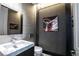 A unique powder bathroom features metal interior, rivet decor, and a white marble sink at 12124 Kite Hill Ln, Las Vegas, NV 89138