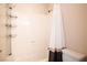 Bathroom with a shower-tub combo and a neutral-toned shower curtain at 12124 Kite Hill Ln, Las Vegas, NV 89138