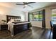 Tranquil bedroom with hardwood floors and natural light overlooking the pool at 12124 Kite Hill Ln, Las Vegas, NV 89138