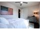 Cozy bedroom features wood-look floors, ceiling fan, and rustic American flag wall decor at 12124 Kite Hill Ln, Las Vegas, NV 89138