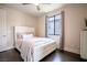 Bright bedroom with hardwood floors, a white bedframe, and a large window at 12124 Kite Hill Ln, Las Vegas, NV 89138