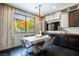 The modern dining area is filled with light from the large windows overlooking the backyard at 12124 Kite Hill Ln, Las Vegas, NV 89138