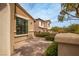 Charming home exterior features manicured landscaping, brick patio, and stucco walls at 12124 Kite Hill Ln, Las Vegas, NV 89138