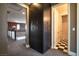 Hallway featuring storage cabinets and an entryway to a bathroom with black and white tile flooring at 12124 Kite Hill Ln, Las Vegas, NV 89138