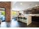A modern kitchen features a large island, bar seating and backyard views at 12124 Kite Hill Ln, Las Vegas, NV 89138