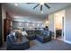 Spacious living area featuring modern decor, a comfortable sectional, and access to a nearby bathroom at 12124 Kite Hill Ln, Las Vegas, NV 89138