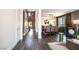 An open-concept living area featuring dark wood flooring, stylish decor, and a view into the dining space at 12124 Kite Hill Ln, Las Vegas, NV 89138