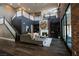 Stunning living room featuring a fireplace, hardwood floors, and stairs to a second-story loft at 12124 Kite Hill Ln, Las Vegas, NV 89138