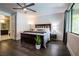 This spacious main bedroom features dark wood floors, sleek furniture, and a bathroom en suite at 12124 Kite Hill Ln, Las Vegas, NV 89138