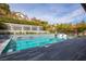 A stunning backyard pool area with a water feature wall and elegant chaise lounge seating at 12124 Kite Hill Ln, Las Vegas, NV 89138