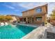 Expansive backyard featuring a sparkling pool, outdoor seating, and meticulous landscaping at 12124 Kite Hill Ln, Las Vegas, NV 89138