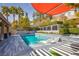 Inviting backyard pool featuring a sun deck with chaise lounges and lush landscaping for privacy at 12124 Kite Hill Ln, Las Vegas, NV 89138