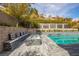 Charming outdoor area features a cozy seating area with a fire pit near the refreshing pool at 12124 Kite Hill Ln, Las Vegas, NV 89138