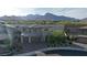 View of a modern home, surrounded by lush landscaping, featuring a mountain backdrop at 12428 Lincoln Creek Ave, Las Vegas, NV 89138