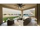 Cozy covered patio with stylish outdoor seating area, overlooking the backyard and pool at 12428 Lincoln Creek Ave, Las Vegas, NV 89138