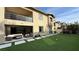 Backyard with artificial turf, a patio, and an upper-level balcony at 12428 Lincoln Creek Ave, Las Vegas, NV 89138