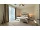 Sunlit bedroom with a cozy rug, neutral tones, and modern furnishings at 12428 Lincoln Creek Ave, Las Vegas, NV 89138
