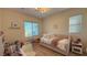 Bright bedroom featuring a bed, swing chair, desk, and plentiful natural light at 12428 Lincoln Creek Ave, Las Vegas, NV 89138