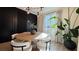 Dining area showcases modern light fixture, dark accent wall, and seating for four at 12428 Lincoln Creek Ave, Las Vegas, NV 89138