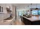 Open kitchen with large island, stainless steel appliances, and views into the dining area at 12428 Lincoln Creek Ave, Las Vegas, NV 89138