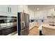 Well-lit kitchen featuring stainless steel appliances, white cabinetry, and marble countertops at 12428 Lincoln Creek Ave, Las Vegas, NV 89138