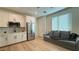Modern kitchen featuring white cabinets, stainless steel appliances, and elegant countertops adjacent to the living area at 12428 Lincoln Creek Ave, Las Vegas, NV 89138