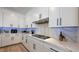 Modern kitchen boasts white cabinets, marble countertops, and stainless steel range at 12428 Lincoln Creek Ave, Las Vegas, NV 89138