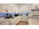 Bright kitchen features white cabinets, marble countertops, and modern appliances at 12428 Lincoln Creek Ave, Las Vegas, NV 89138