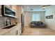 Well-lit living space includes a kitchen, seating area, and modern appliances at 12428 Lincoln Creek Ave, Las Vegas, NV 89138