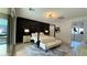 Beautiful main bedroom featuring a dark accent wall, stylish lighting and a sitting area at 12428 Lincoln Creek Ave, Las Vegas, NV 89138