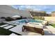 Stunning pool area with lounge chairs, a fire pit, and lush landscaping, creating a luxurious outdoor oasis at 12428 Lincoln Creek Ave, Las Vegas, NV 89138