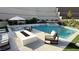 Beautiful pool area with a modern fire pit, comfortable seating, and lush landscaping, ideal for outdoor entertaining at 12428 Lincoln Creek Ave, Las Vegas, NV 89138