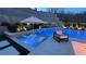 Pool view featuring illuminated lounge chairs under an umbrella with a waterfall feature at 12428 Lincoln Creek Ave, Las Vegas, NV 89138