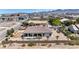 Aerial view of desert landscape featuring a home with block wall, covered patio, and desert landscaping at 12720 Davis Wright Ct, Henderson, NV 89044