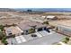 An aerial view of desert landscape with a modern home featuring an attached garage and desert landscaping at 12720 Davis Wright Ct, Henderson, NV 89044